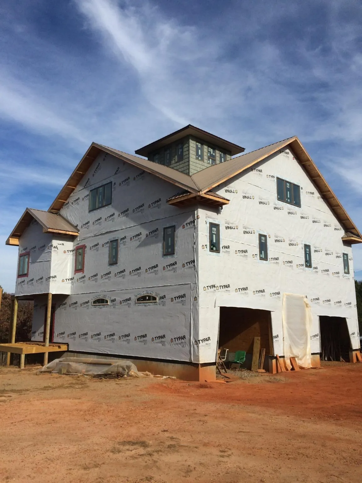 New two story house under construction with a cupola and gabled roofs in Upton